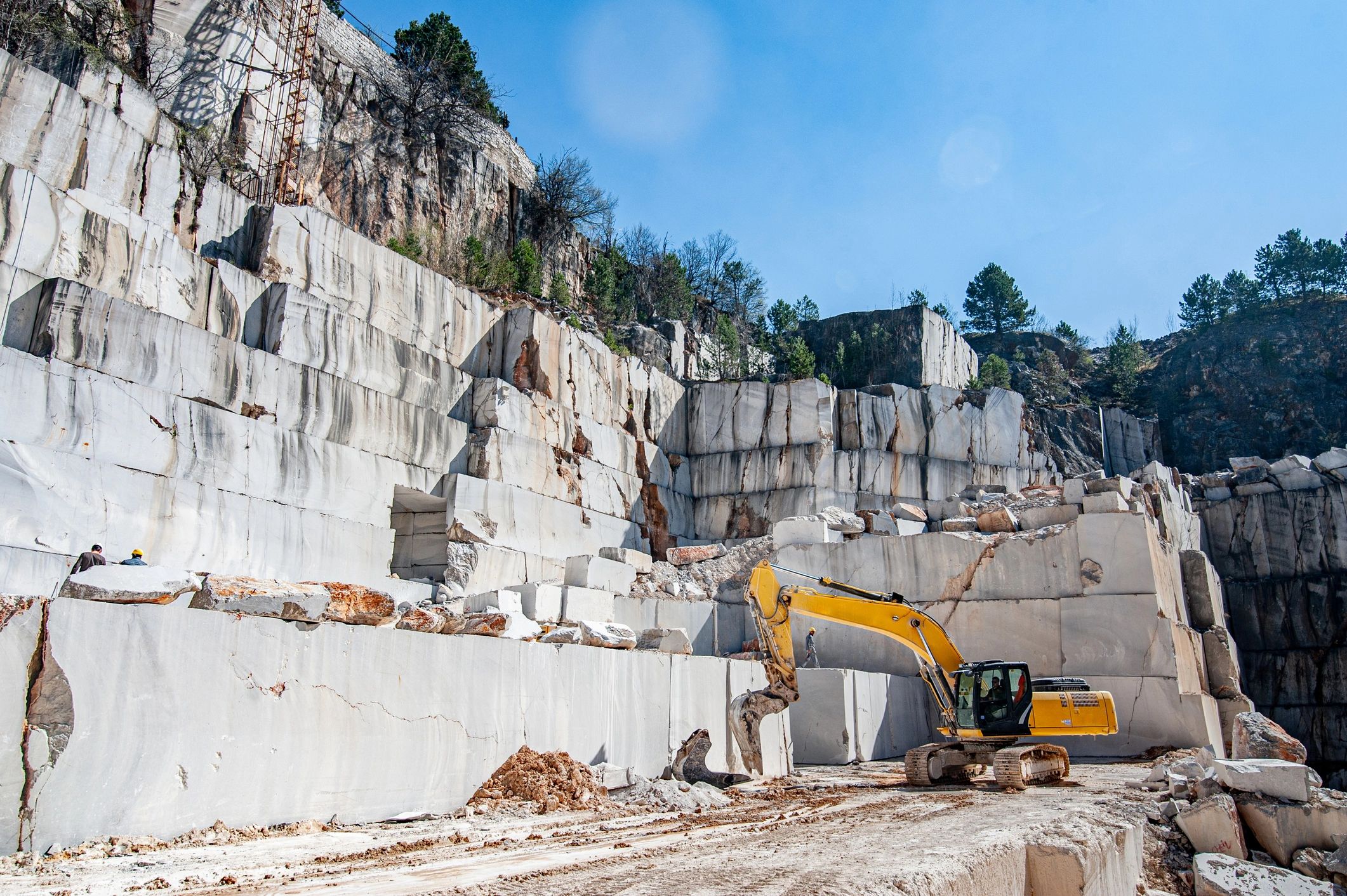 Marble quarry with earth mover and cut stone blocks
