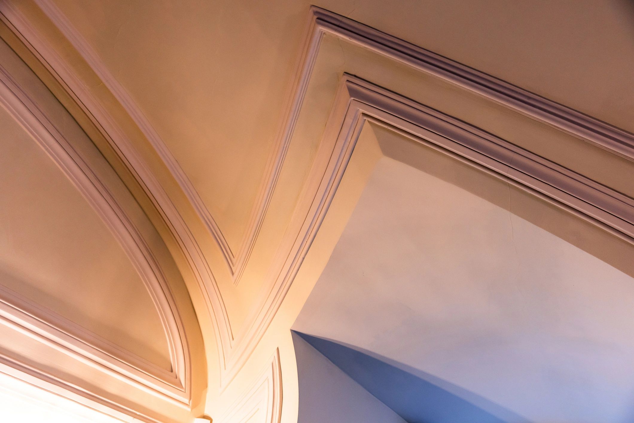 Arched ceiling detail with warm light and blue shadows