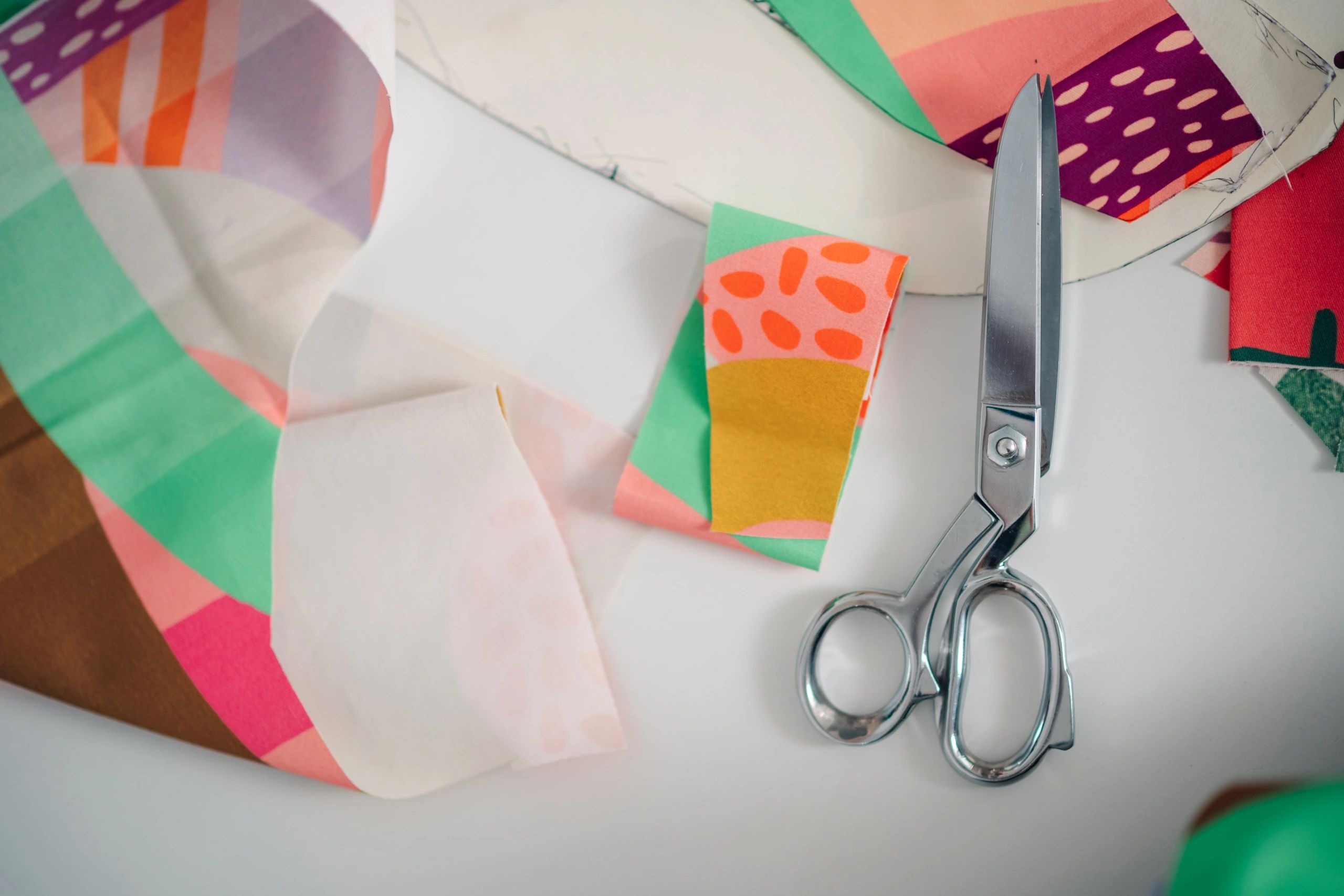 Colourful fabric pieces and scissors in a textile studio workroom