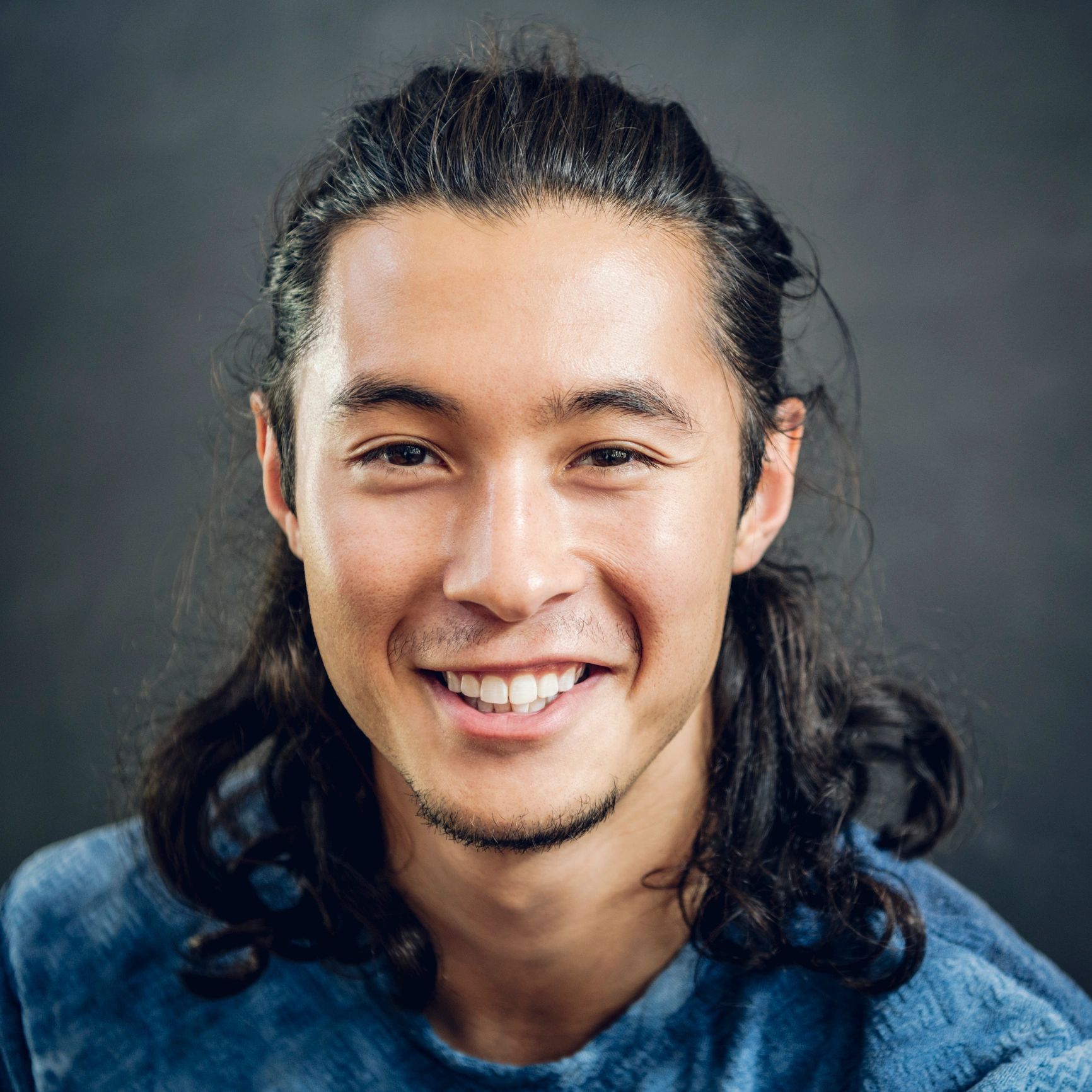 Portrait of a smiling man with long hair